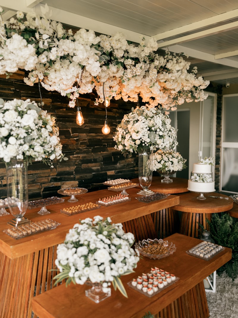 A celebration table beneath a canopy of white florals