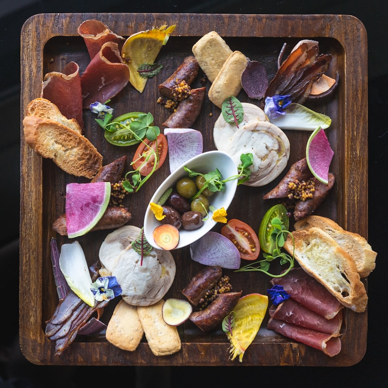 An assortment of hors d'oeuvres arranged on a dark tray