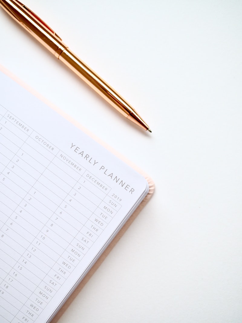 A printed run-of-show and pen on a planning desk