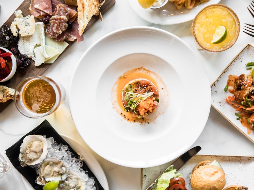 An overhead view of a first course and sides on a set table