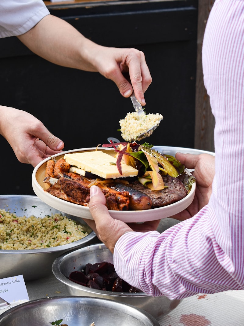 Guests serving themselves from a buffet of hot dishes