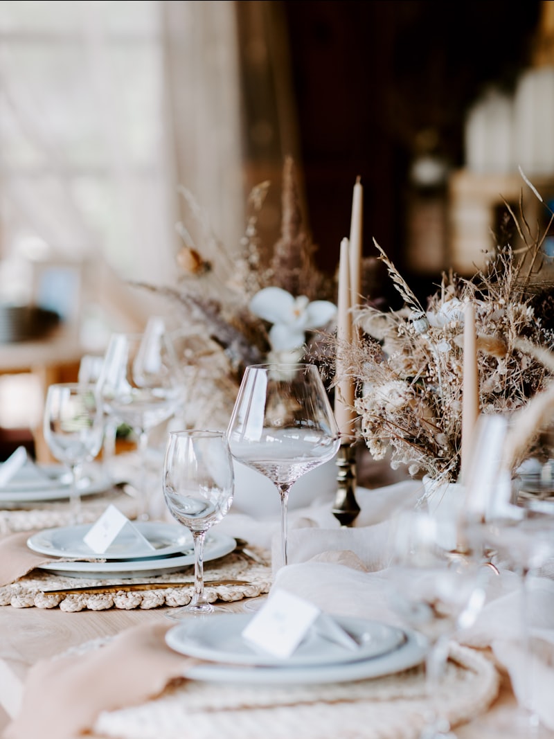 A wedding table set with tapered candles, linen and place settings